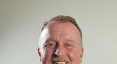 Board of Director Chris Murray in a suit and tie
