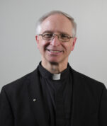 Headshot of Fr. Davis priest in his clerics